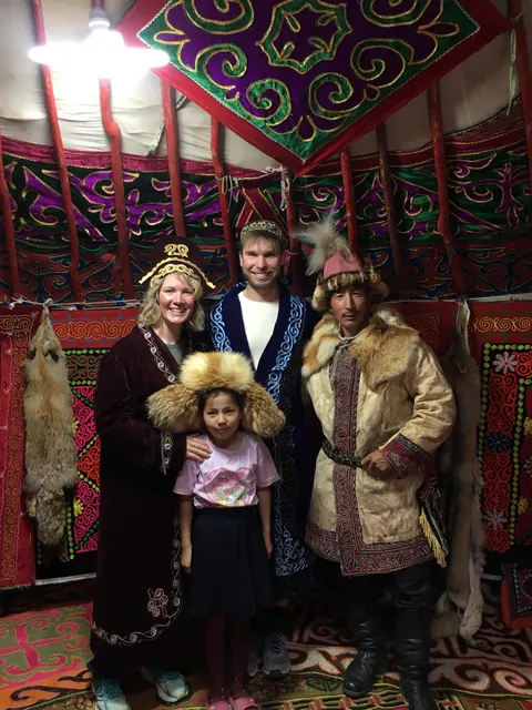 Family in traditional dress inside a Kazakh ger