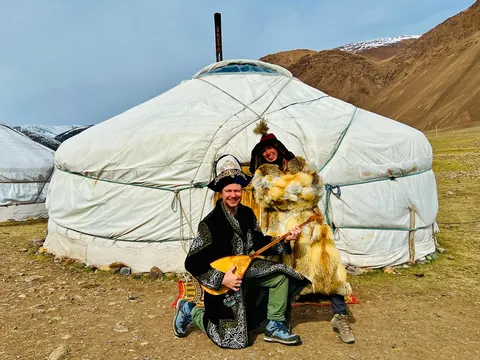 Traveler in traditional costume in front of a ger
