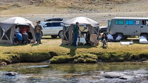 Camp tents beside a river