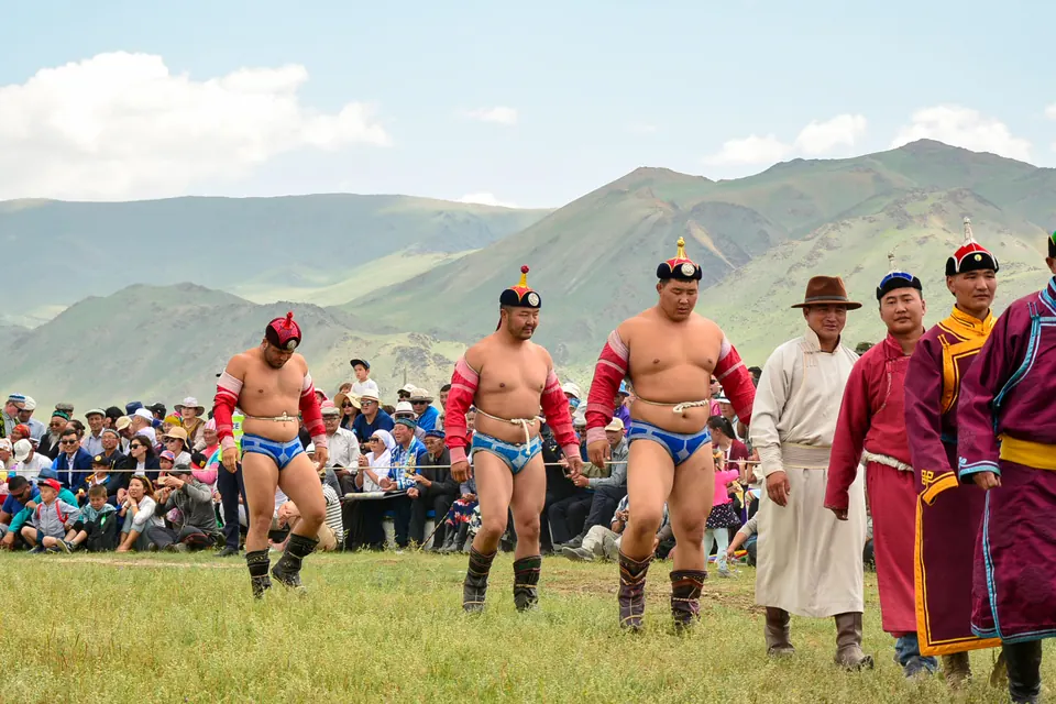 Mongolian wrestlers entering the field at a countryside Naadam