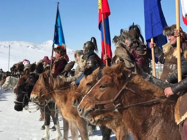 Eagle hunters with flags at a winter festival
