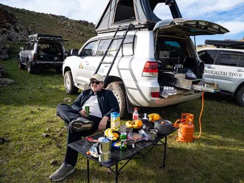 White Toyota Land Cruiser 200 with rooftop tent and camp kitchen