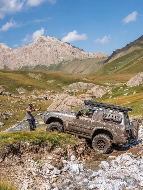 Off-road vehicle crossing a mountain stream